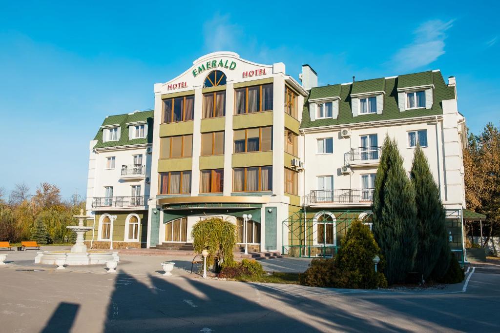 a large building in front of a street at Emerald Hotel in Tolyatti