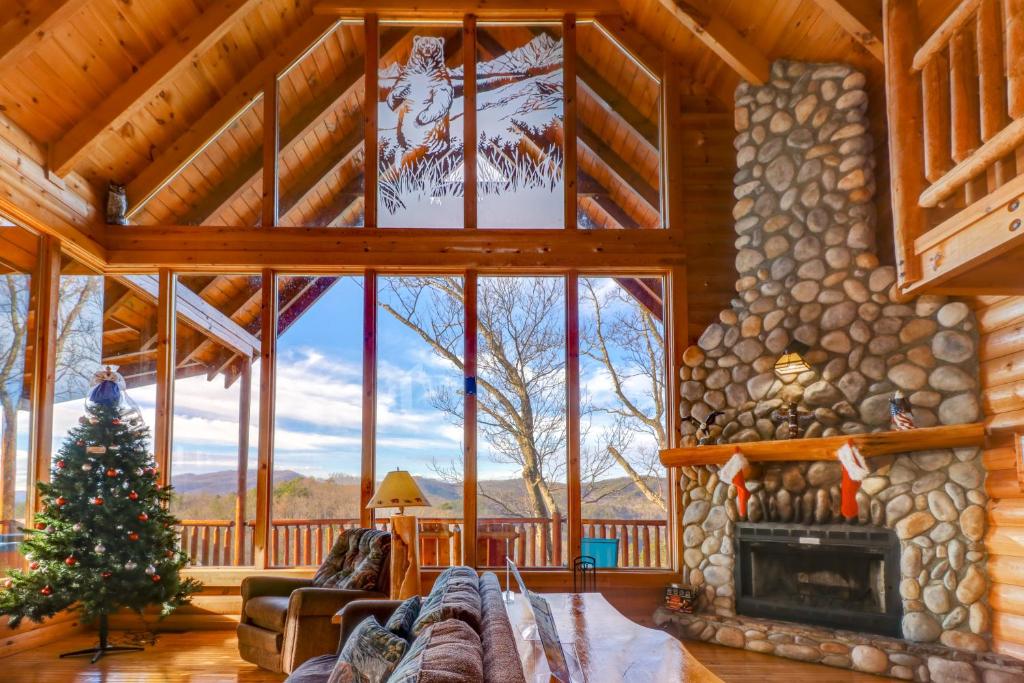 a living room with a fireplace and a christmas tree at Kodiak #45 in Sevierville