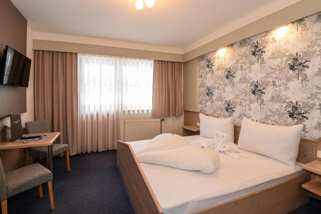 Postel nebo postele na pokoji v ubytování Golf & Skipension Krug