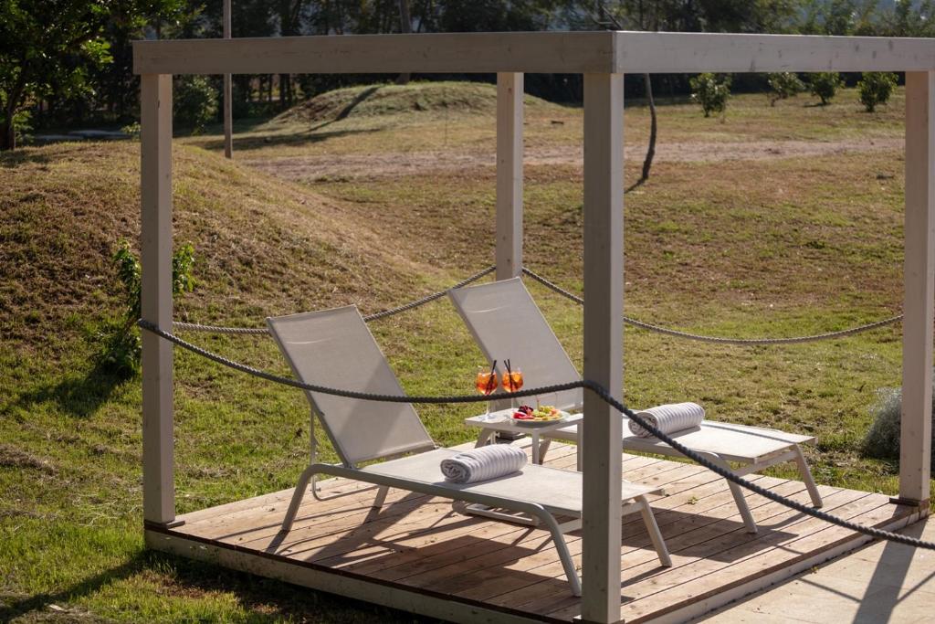 a gazebo with two chairs and a table at Masseria Mongiò dell'Elefante in Otranto