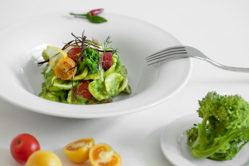 a plate of salad with a fork on a table at Masseria Mongiò dell'Elefante in Otranto