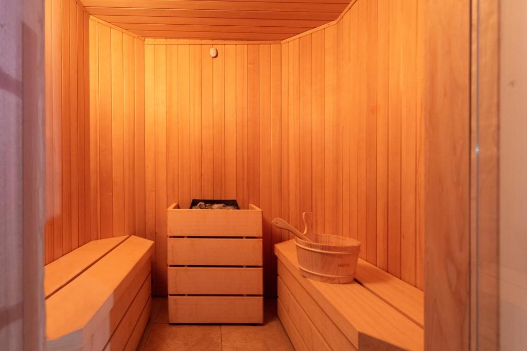 a sauna with two benches and a bucket in it at Masseria Mongiò dell'Elefante in Otranto