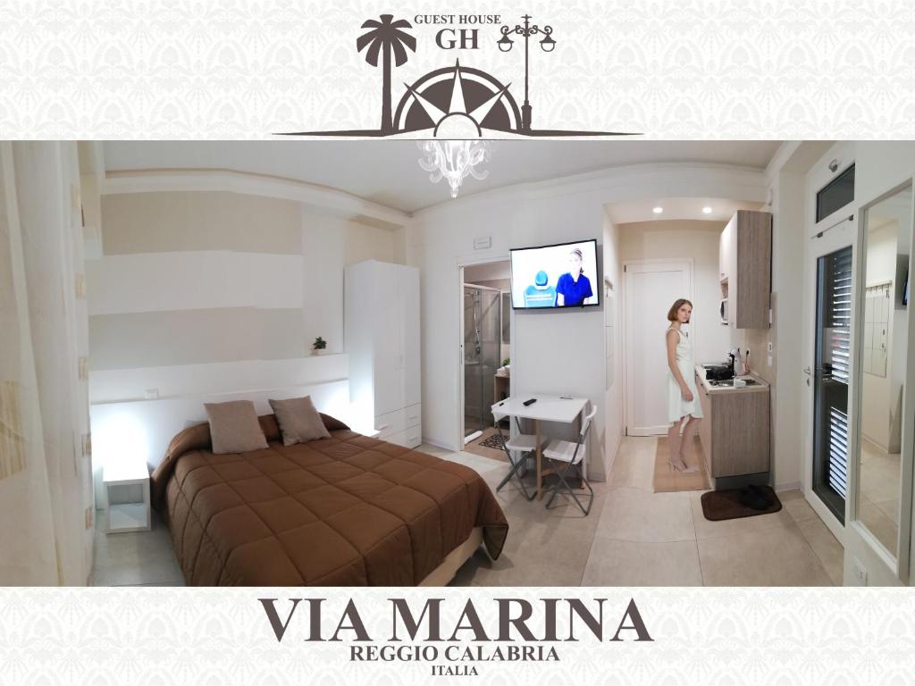 a bedroom with a bed and a woman standing in a room at Guest House B&B Via Marina in Reggio di Calabria