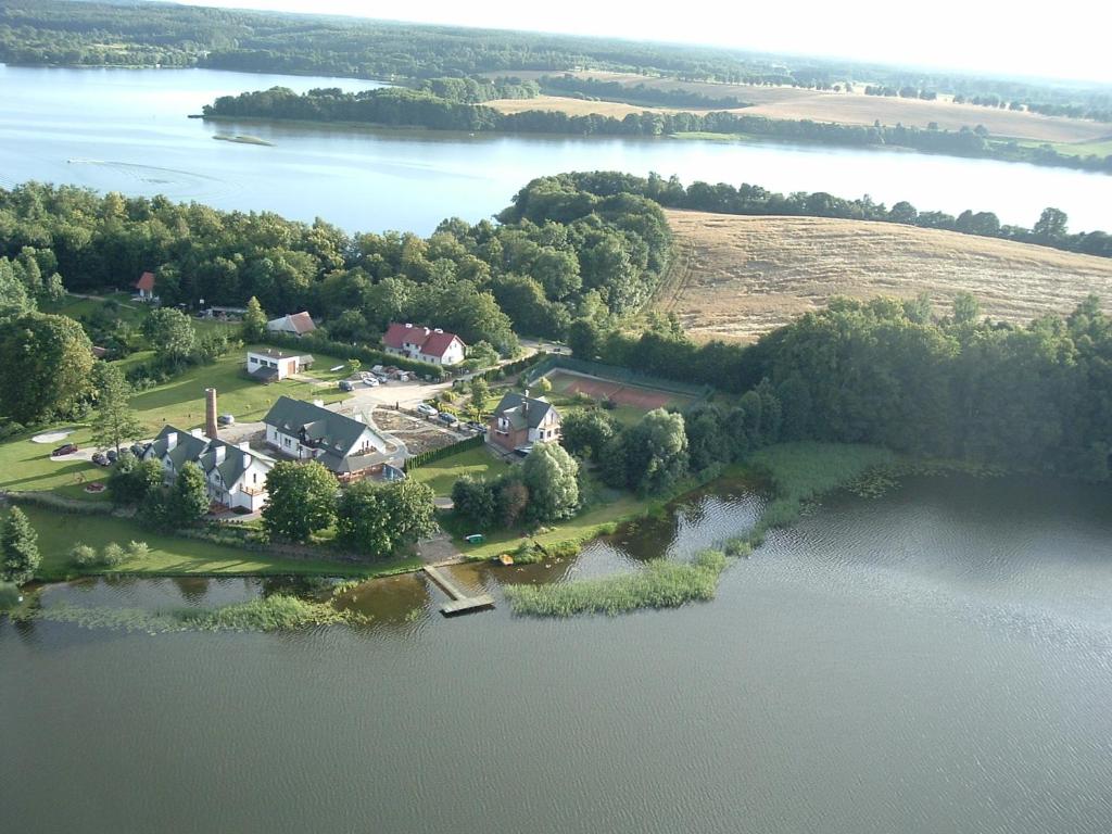 an aerial view of a house on an island in a lake at Siedlisko Agroturystyczne in Mrągowo