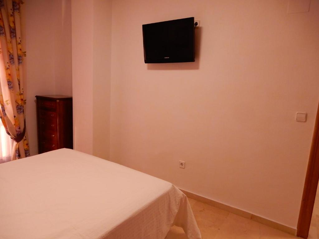 Televízia a/alebo spoločenská miestnosť v ubytovaní Edificio 1º línea de playa, en paseo marítimo de Torrevieja, Alicante, Costa Blanca