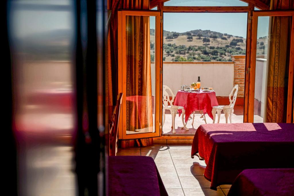 a dining room with a table and chairs on a balcony at Hotel Alfonso VIII in Santa Elena