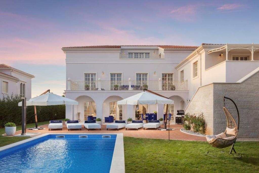 a villa with a swimming pool and a house at Villa Hermitage in Vabriga