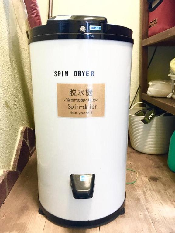 a cooler sitting on a floor next to a shelf at Beach Side Inn Shirahama in Shimoda