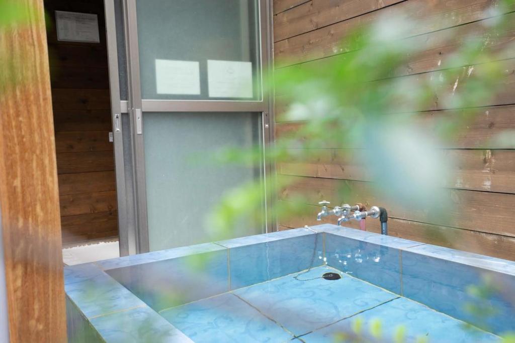 a bathroom with a sink and a faucet at Beach Side Inn Shirahama in Shimoda