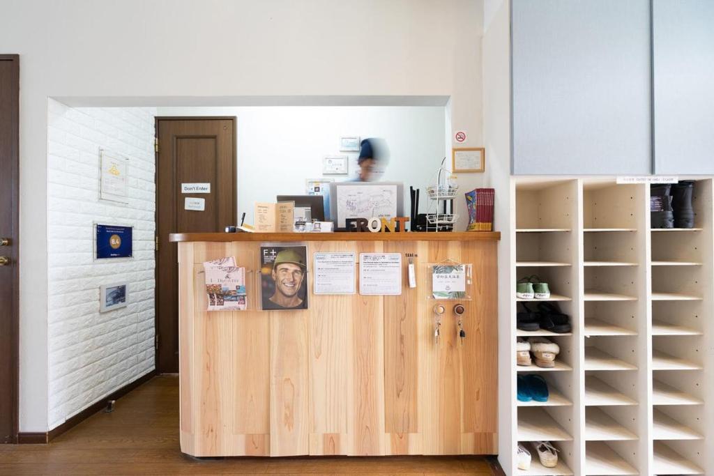 a woman standing at a counter in a room at Beach Side Inn Shirahama in Shimoda