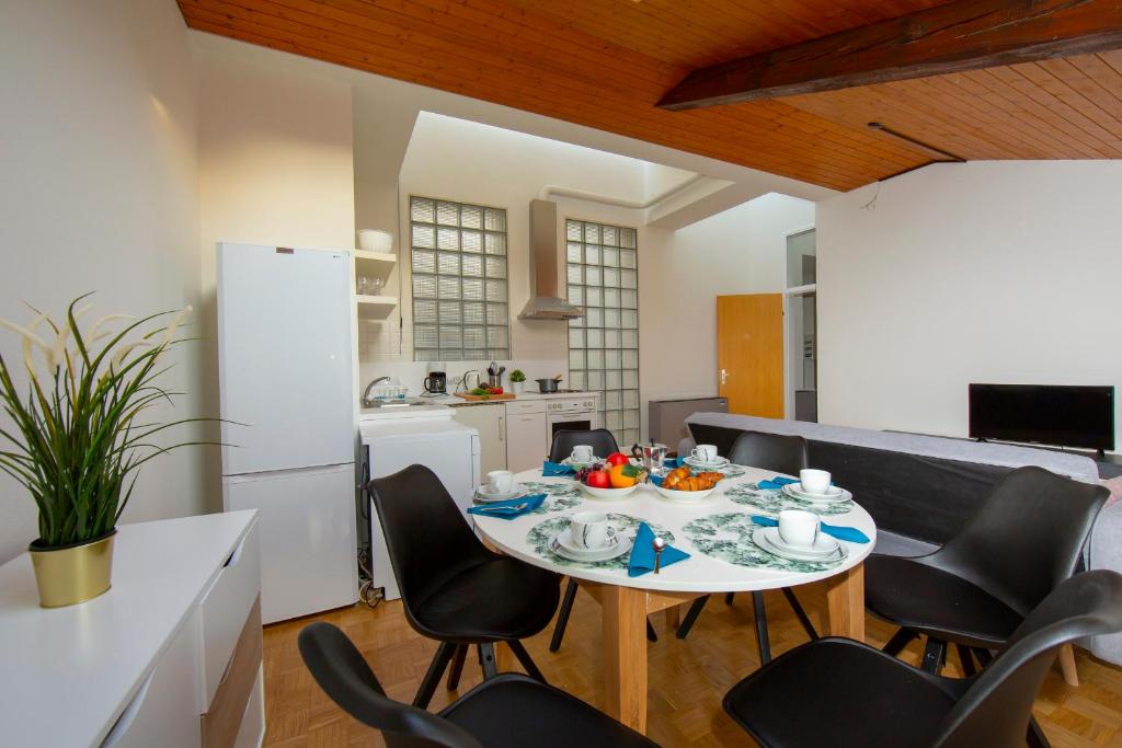 - une salle à manger et une cuisine avec une table et des chaises dans l'établissement Mansarda Gargantini, à Lugano