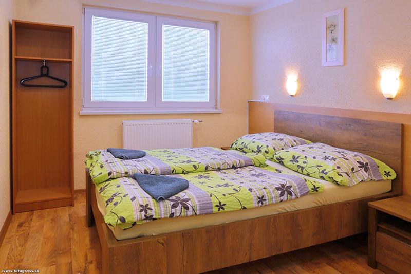 Postel nebo postele na pokoji v ubytování Wellness penzión Maxim