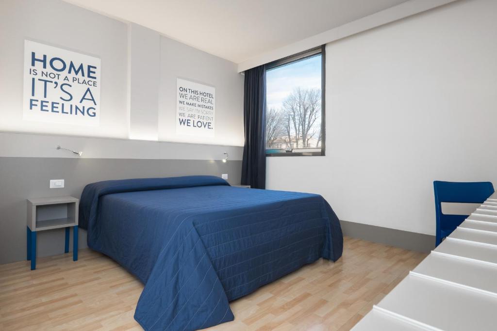 Postel nebo postele na pokoji v ubytování Hotel Martini