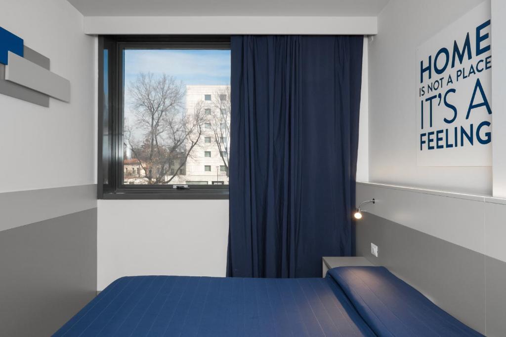 Postel nebo postele na pokoji v ubytování Hotel Martini