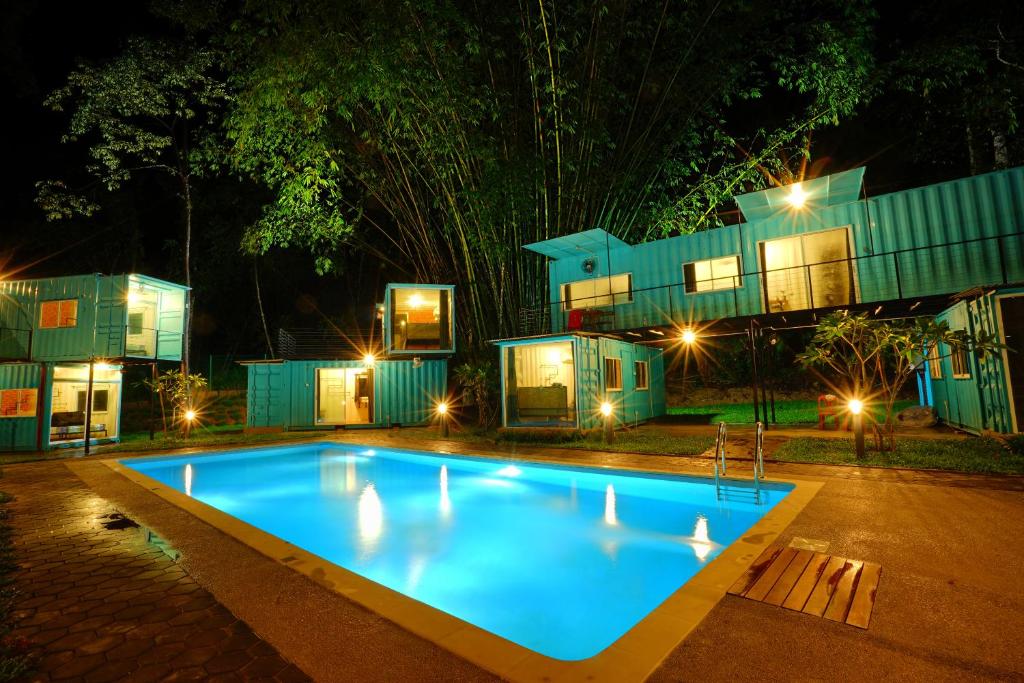 a swimming pool in front of a house at night at Sarang by the brook in Kuala Kubu Baharu