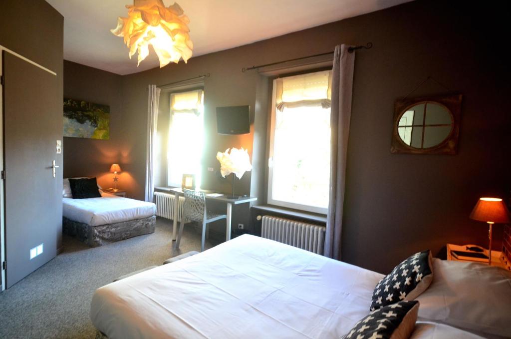Postel nebo postele na pokoji v ubytování Hôtel Vauban