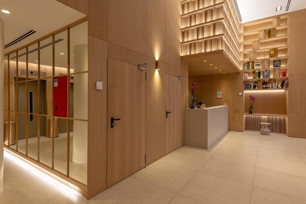 a hallway with a large door in a building at Apartamentos Recoletos in Madrid