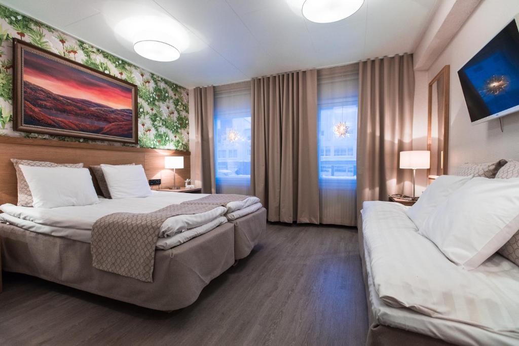 Postel nebo postele na pokoji v ubytování Hotel Aakenus