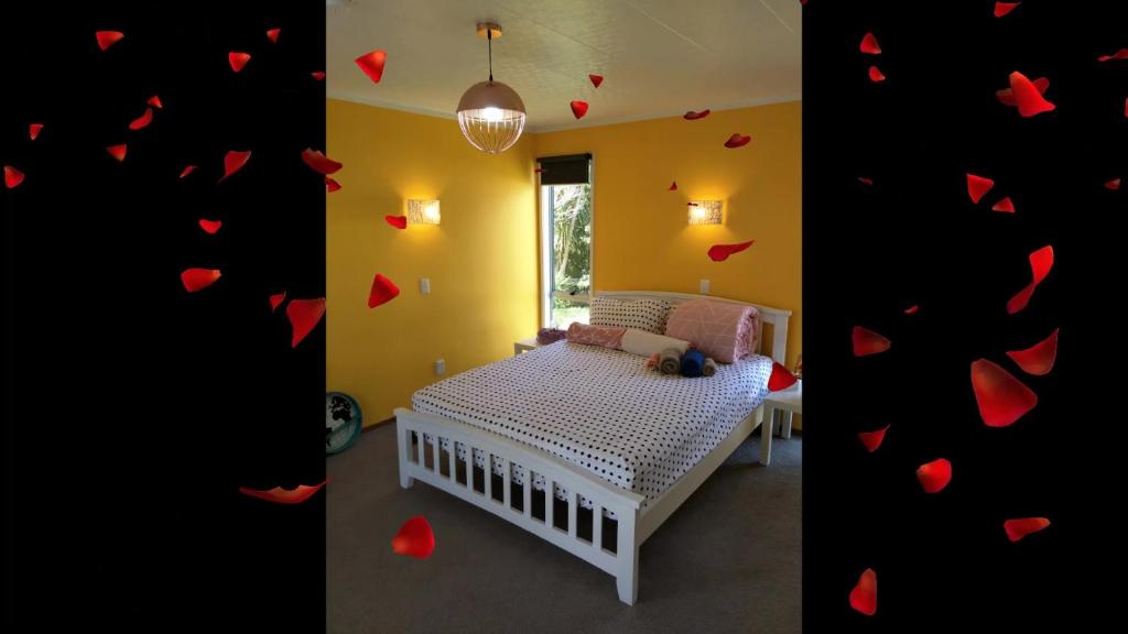 a bedroom with a bed with hearts on the wall at Wendy's Holiday Home in Auckland