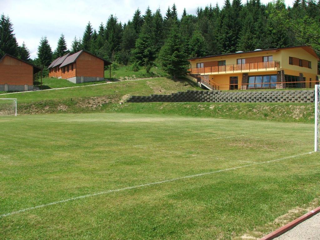 a soccer field in front of a building at Holiday Park Orava - Hotel Orava in Dolný Kubín
