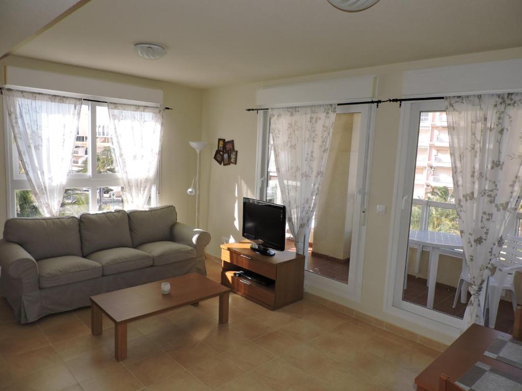 A television and/or entertainment centre at La Manga Apartments - Punta Cormoran