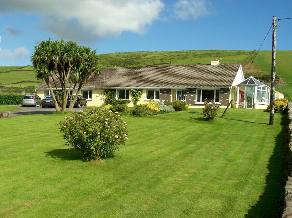 a house with a large lawn in front of it at Duinin House B&B in Dingle
