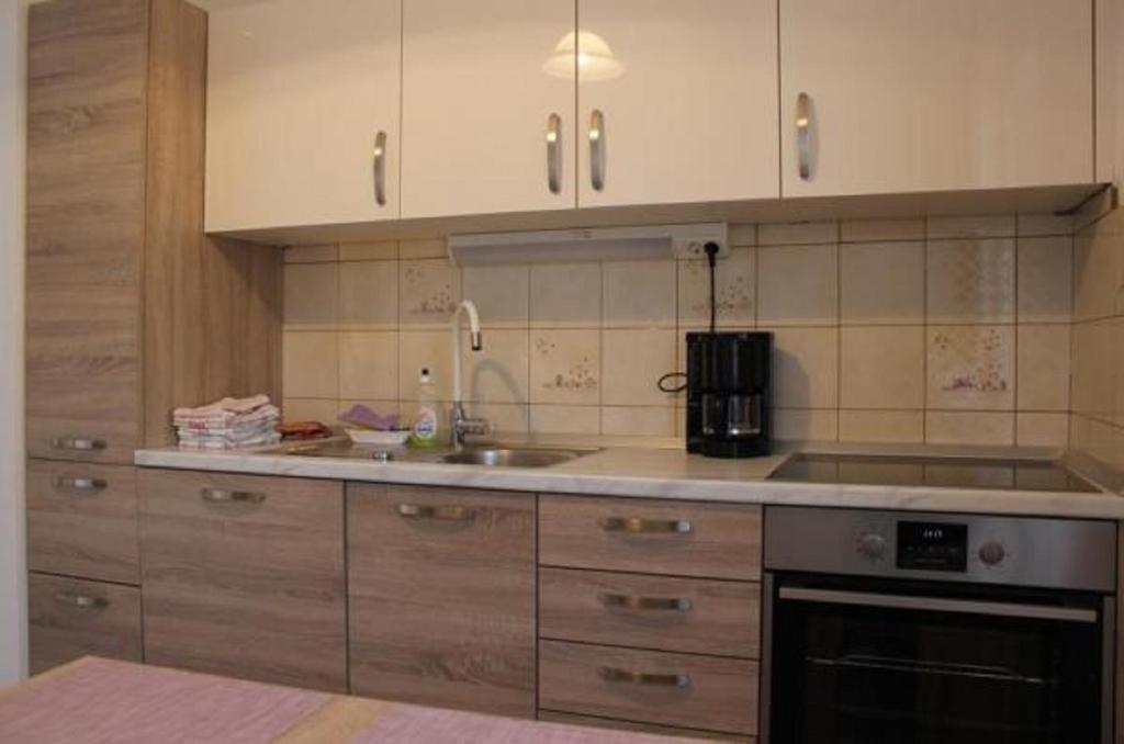 a kitchen with a sink and a stove top oven at Apartments Rozi in Bovec