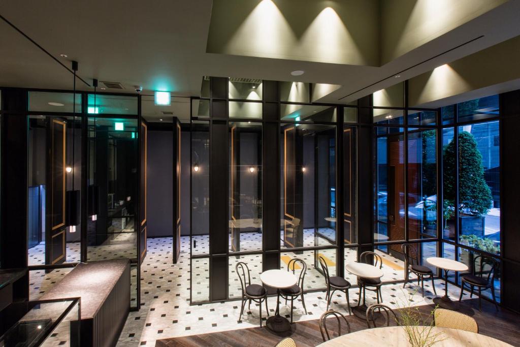 a balcony with tables and chairs in a building at Hotel Star Gangnam in Seoul