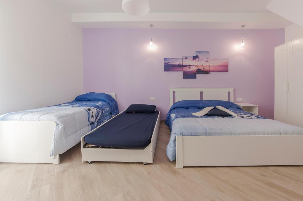 Łóżko lub łóżka w pokoju w obiekcie Casa Rossini