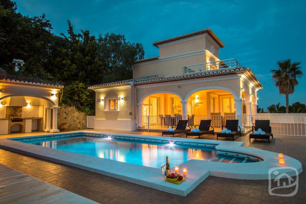 a swimming pool in the backyard of a house at Villa Lou by Abahana Villas in Moraira