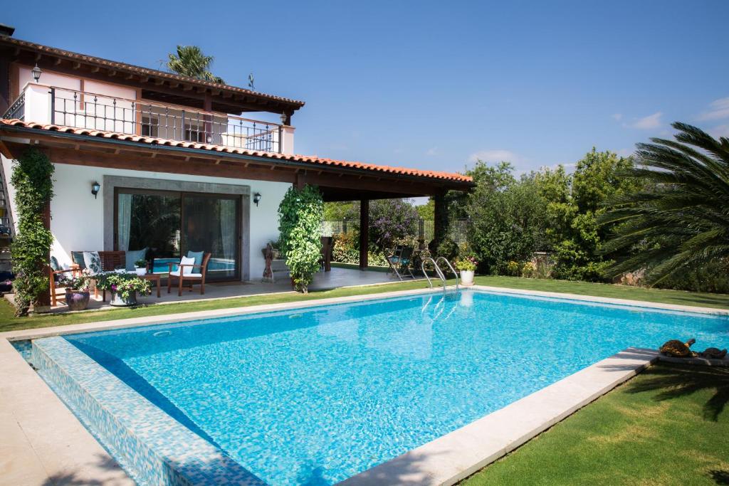 a swimming pool in front of a house at Villa Mertcan by Important Group Travel in Yalıkavak