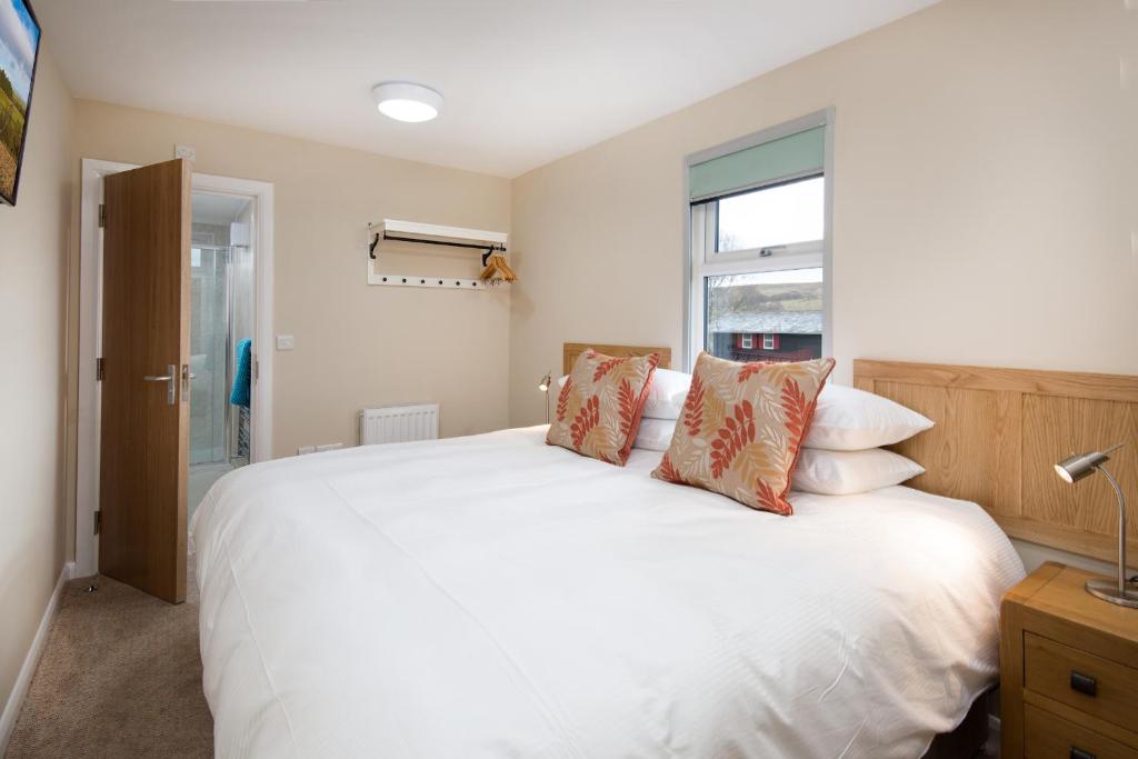 a bedroom with a large white bed with pillows at Brown Rigg Guest Rooms in Bellingham