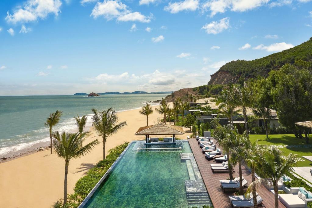 an aerial view of a resort with a swimming pool and the beach at Anantara Quy Nhon Villas in Quy Nhon