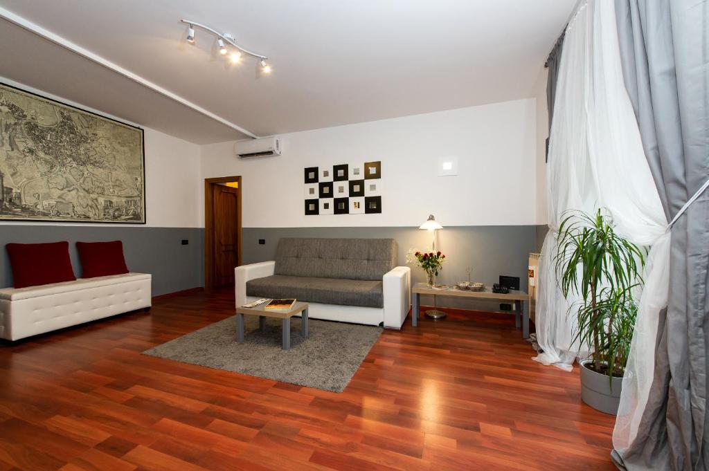 a living room with a couch and a table at Flaminia 36 Luxury Home in Rome