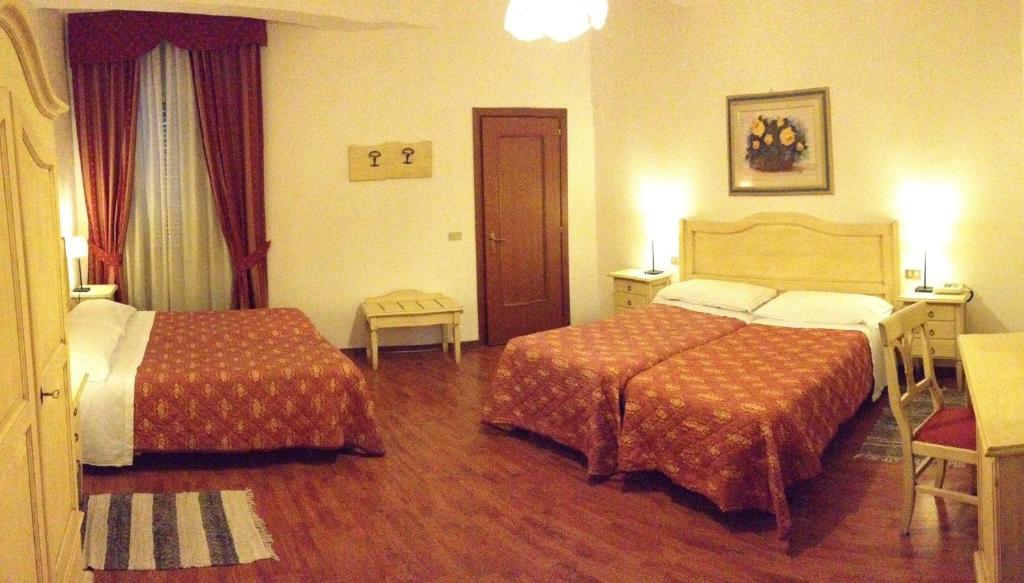 Posteľ alebo postele v izbe v ubytovaní Hotel Umbria