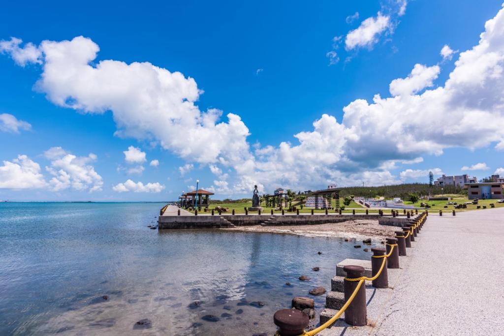 a beach with a pier and the water at Malibu OceanView Homestay in Magong