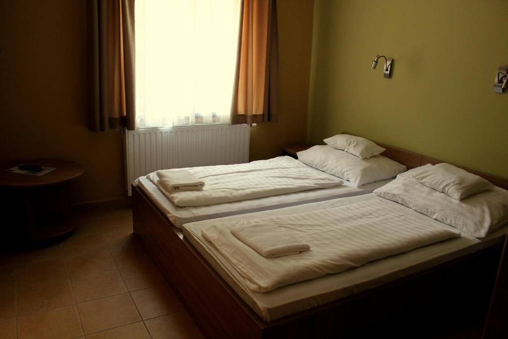Postel nebo postele na pokoji v ubytování BF Hotel