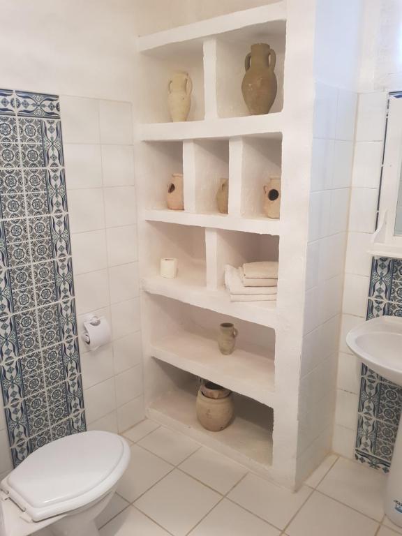 a bathroom with a toilet and a sink at Menzel Churasco Djerba in Aghīr