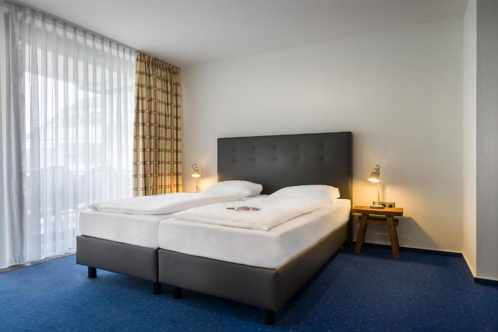 Postel nebo postele na pokoji v ubytování Hotel Strohgäu