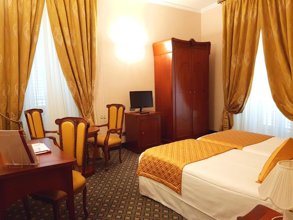 Postel nebo postele na pokoji v ubytování Hotel Berchielli