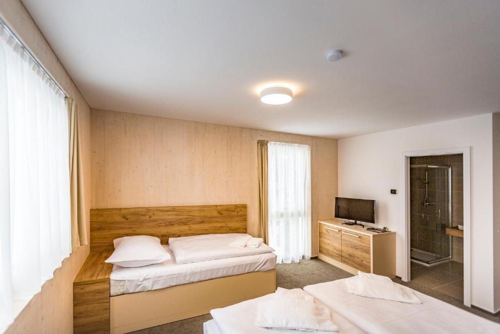 Postel nebo postele na pokoji v ubytování Hotel Monínec - Depandance Nová Javorka