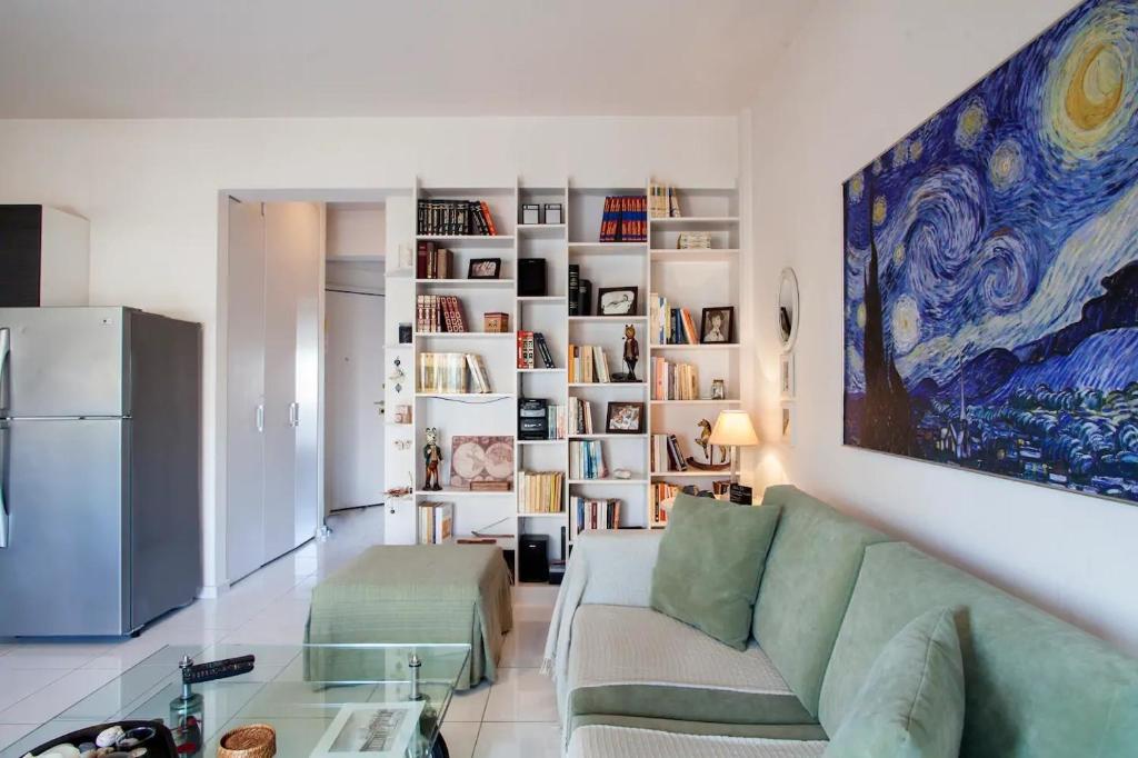 a living room with a green couch and a refrigerator at Stylish Boutique Condo in Heraklio Town