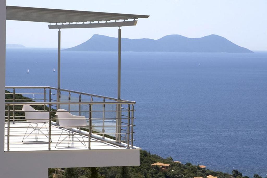 a balcony of a house with a view of the ocean at Dream View Villas in Sivota