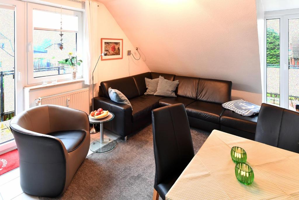 a living room with a couch and chairs and a table at Haus Hamburg in Cuxhaven