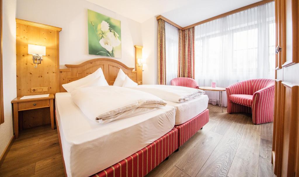 Postel nebo postele na pokoji v ubytování Hotel Grieshof