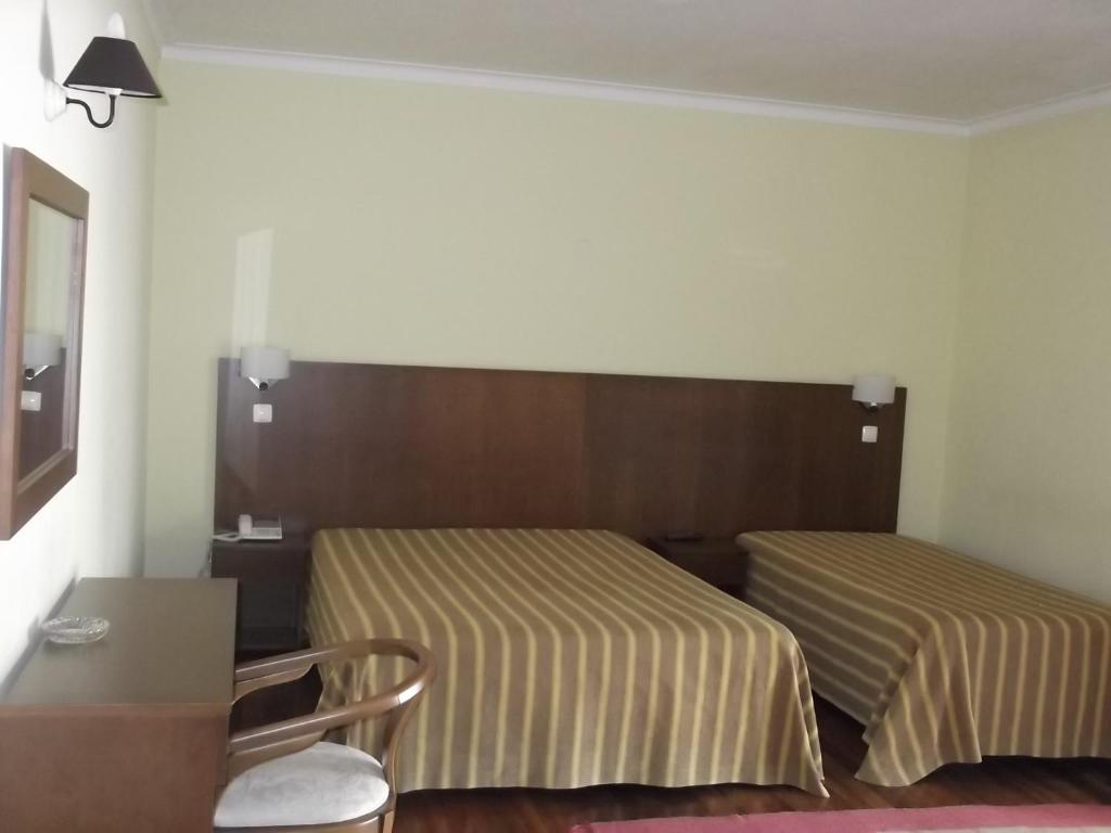 Postel nebo postele na pokoji v ubytování Hotel Minho Belo