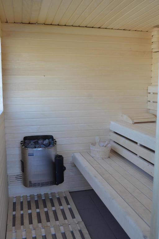a sauna with a bench and a bucket in it at Vue d'en Haut in Durbuy