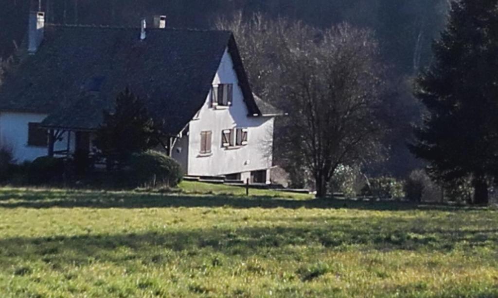 a white house in the middle of a field at GRAND GITE RURAL in Salmiech