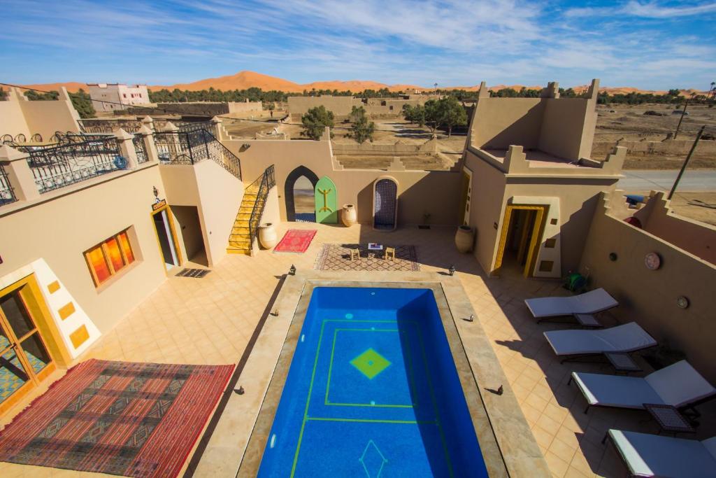 an aerial view of a house with a swimming pool at Hassilabiad Appart Hotel in Merzouga