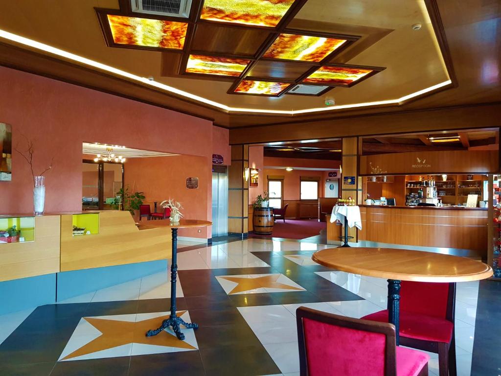 a lobby with a star on the floor and a table at Hotel Cigoland in Kintzheim